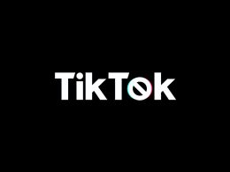 Siyah üzerine beyaz yazıyla TikTok yazıyor, ancak o harfi yasaklama sembolü gibi ve etrafında TikTok logosuna benzer renkli dalgalar var.